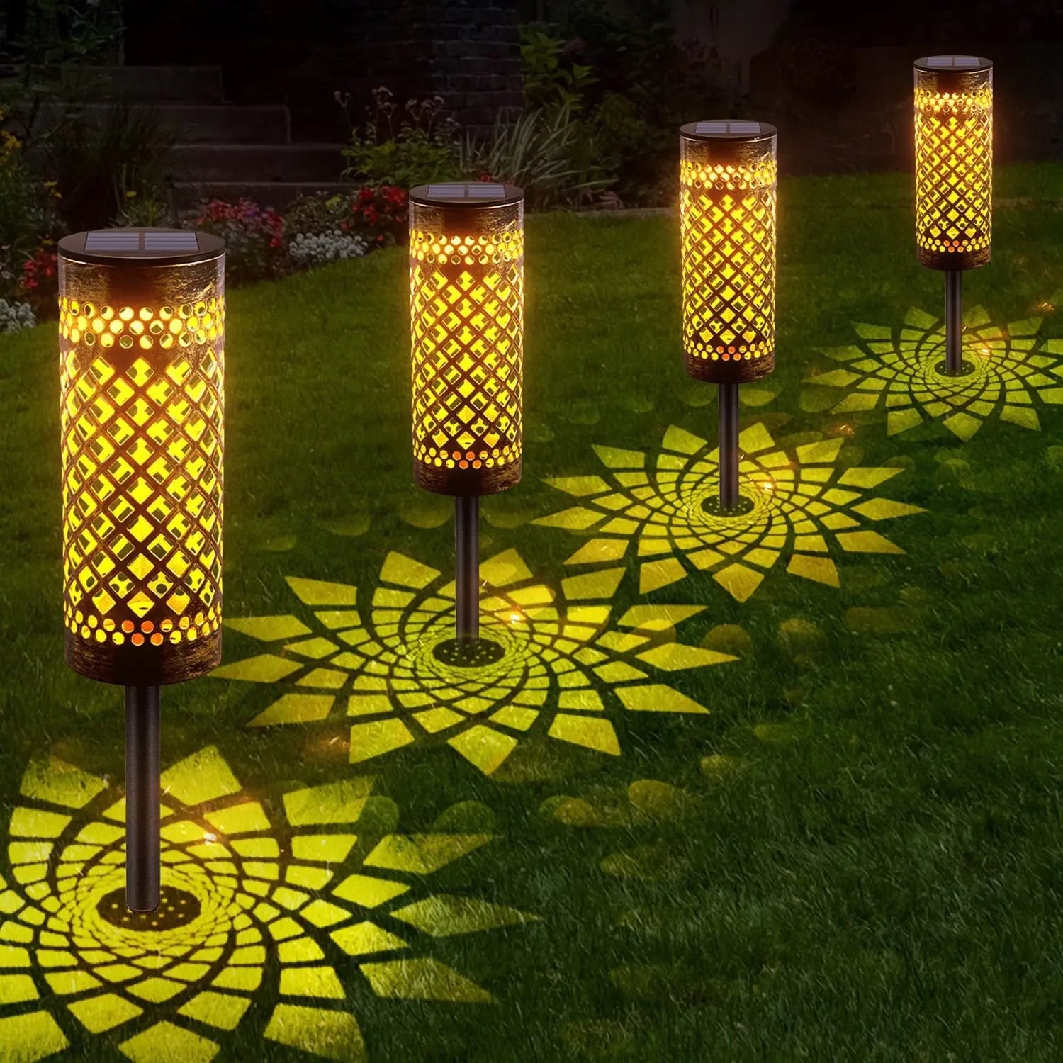 Row of waterproof solar lawn lights glowing warmly on grass at night