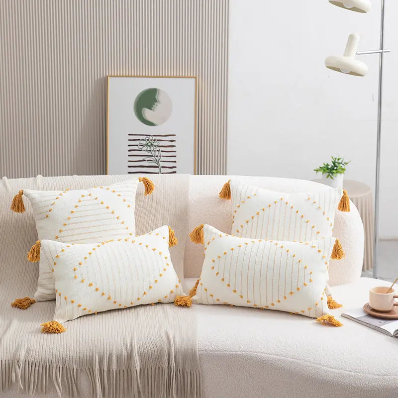 Yellow flower print cushion covers styled on a sofa with boho decor accents
