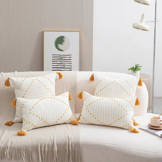 Yellow flower print cushion covers styled on a sofa with boho decor accents